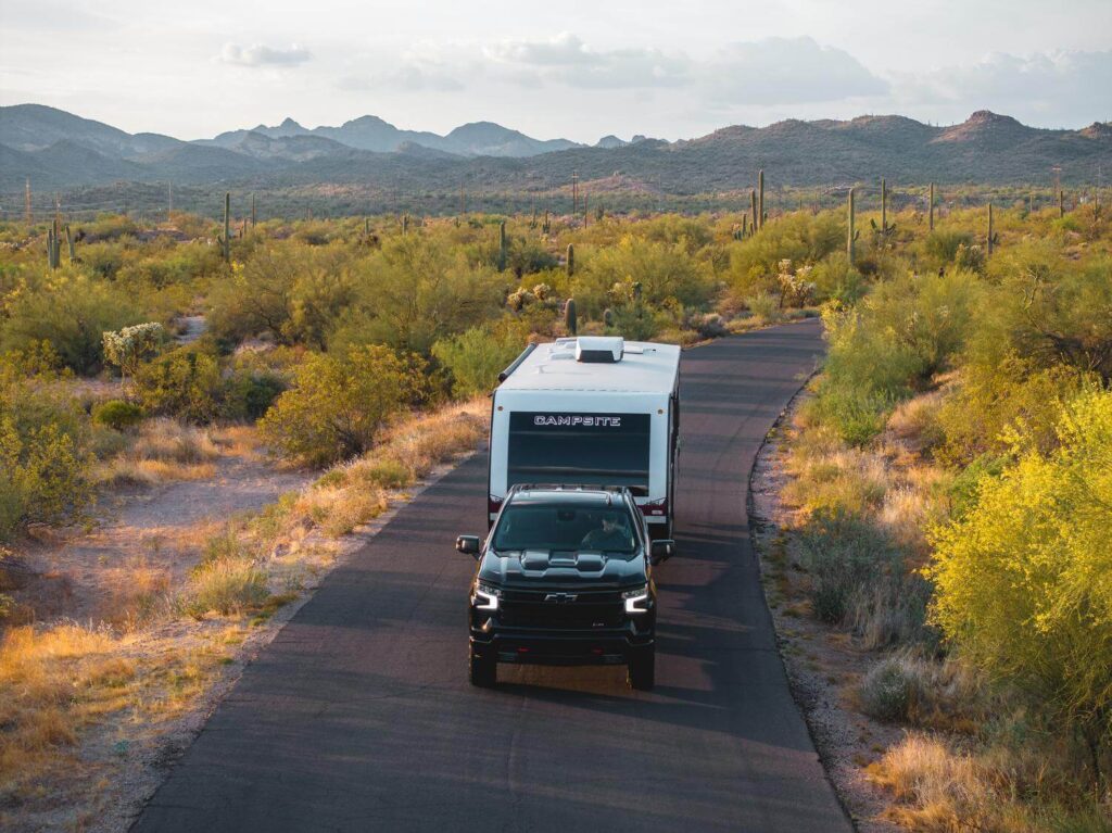 Black truck towing a Campsite Reserve travel trailer RV