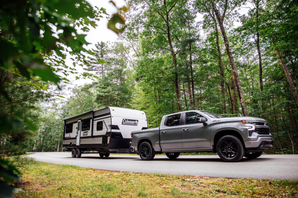 Truck towing a Keystone Coleman travel trailer