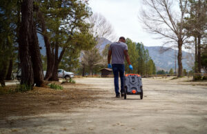 Man pulling RV waste tote to the dump station