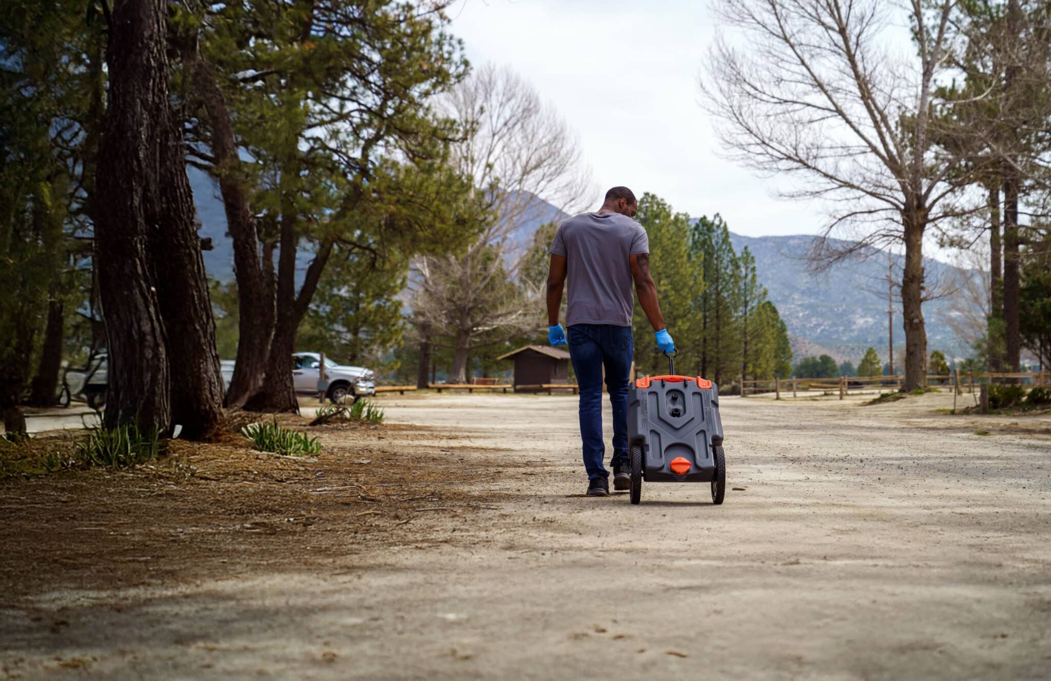 Man pulling RV waste tote to the dump station
