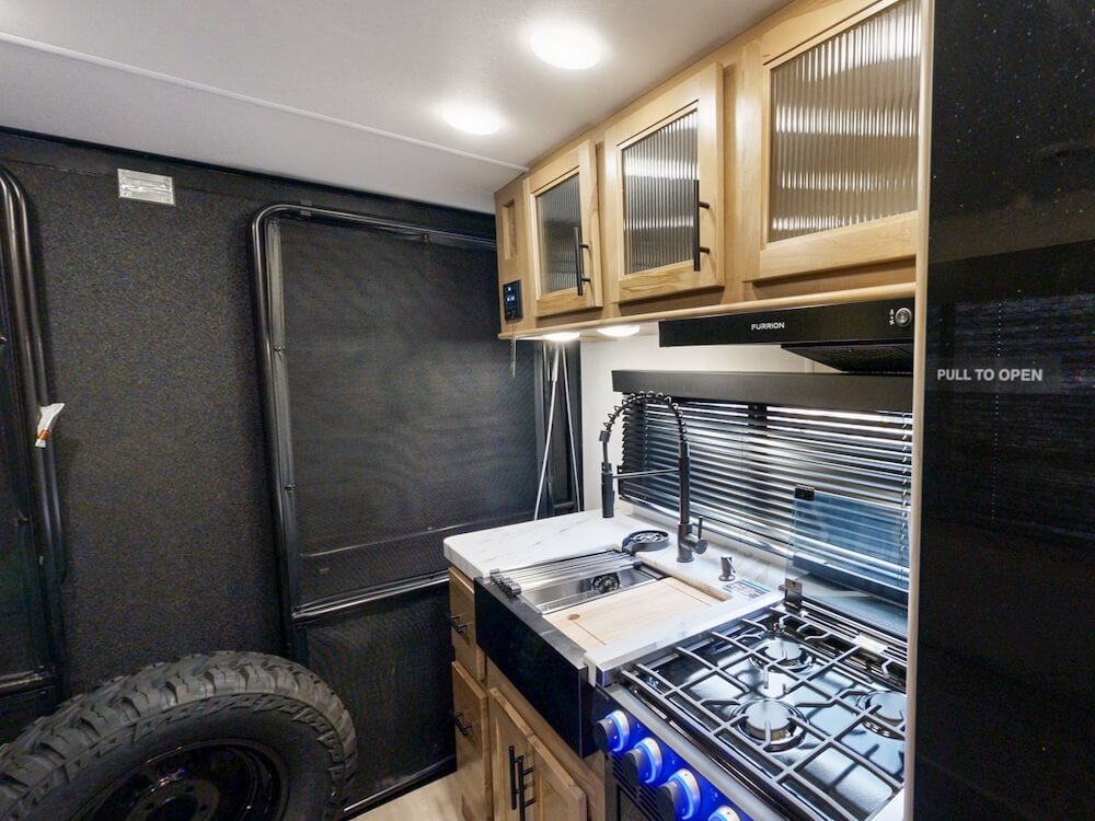 toy hauler travel trailer interior seating and kitchen
