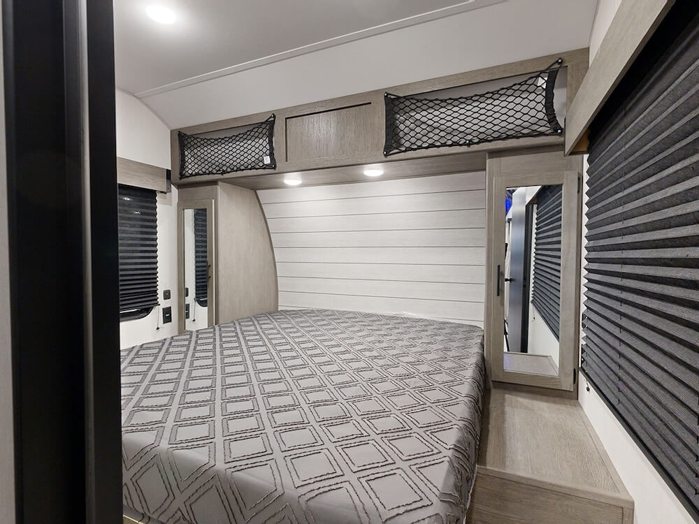 interior garage and bedroom of a toy hauler travel trailer
