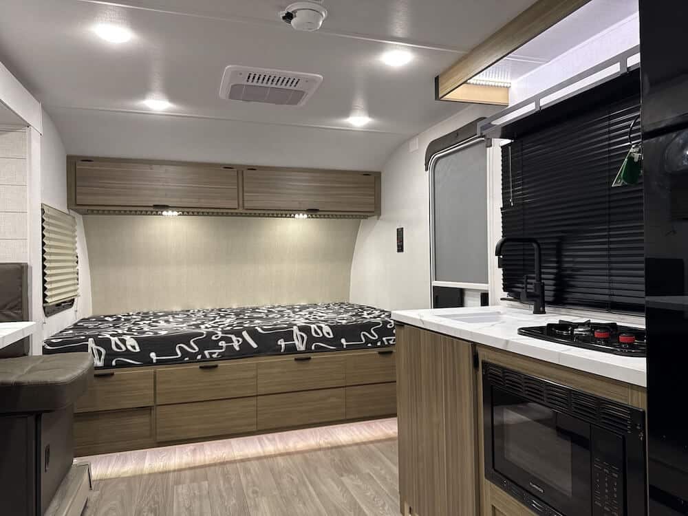 Image of the interior of the Salem FSX 178ICE featuring the bed and part of the kitchen to the right. 