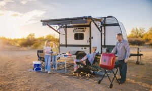 Family camping outside Coleman 13B travel trailer