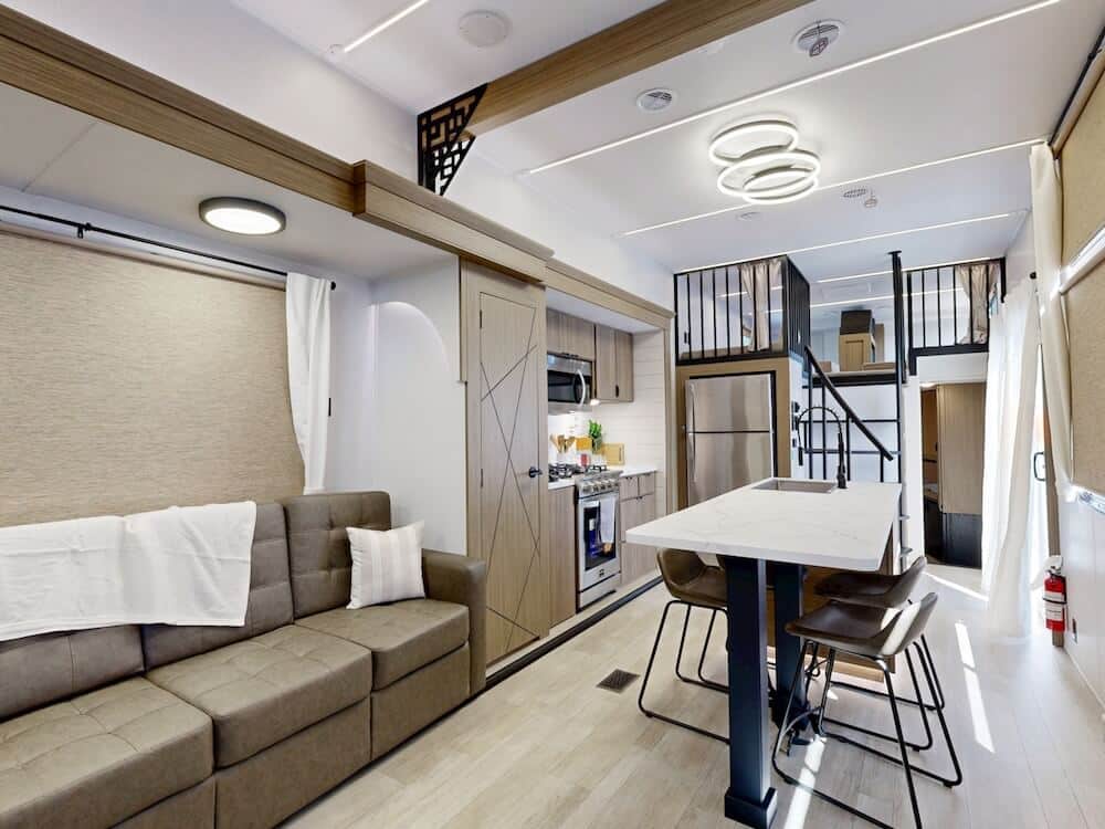 Interior image of the Salem Grand Villa 42ICE showing part of the sofa, the full kitchen island, oven and refrigerator.