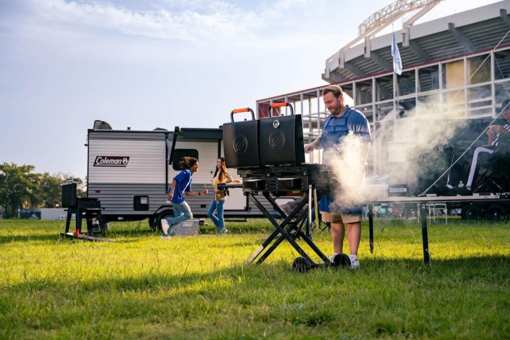 Man cooking on a Blackstone griddle while tailgating at Camping World Stadium