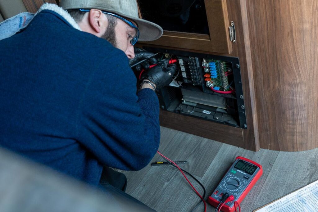 Technician checking RV electrical panel