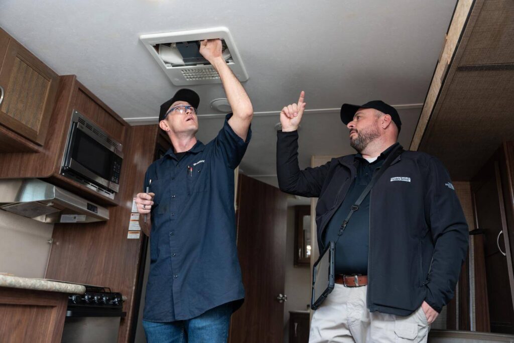 Technicians diagnosing RV air conditioner
