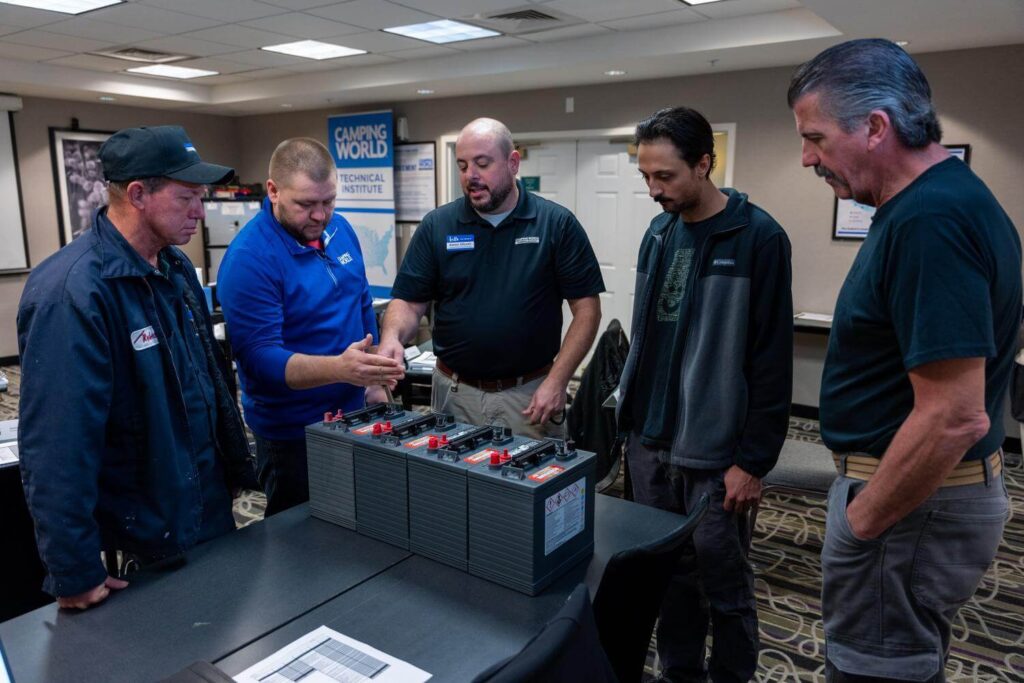 Technicians discussing rv battery maintenance