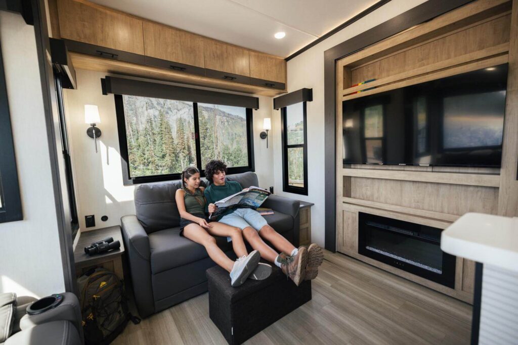 Kids sitting on sofa in 5th wheel