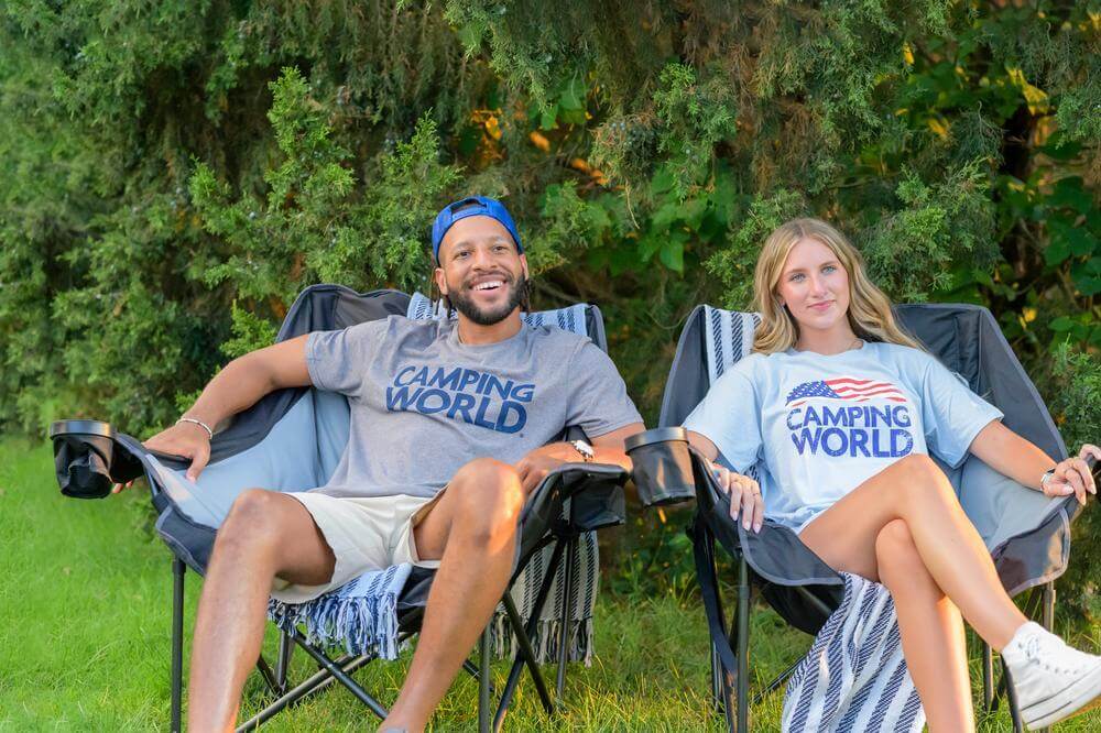 Couple relaxing in comfortable camp chairs