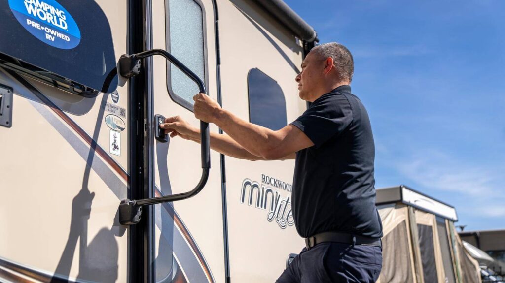 Man opening RV entry door