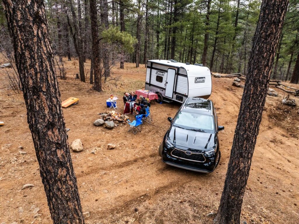 Family and RV at a foreste campsite. 