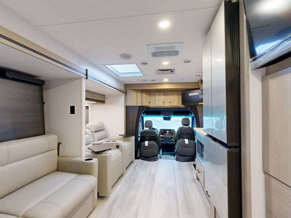 Interior image of the living room facing the drivers cab for the Forest River Forester MBS 2401T Class C RV.