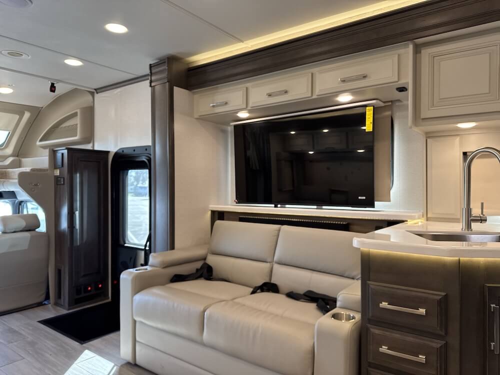 Interior image of the Jayco Seneca Prestige 37M that shows the entrance and the the jackknife sofa.