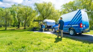 mobile service technician greeting a couple with an RV breakdown on the road