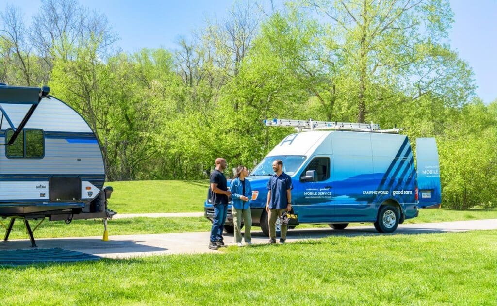 Mobile service technician greeting campers with an RV breakdown