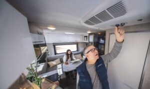 Man testing an RV AC that is Not Cooling