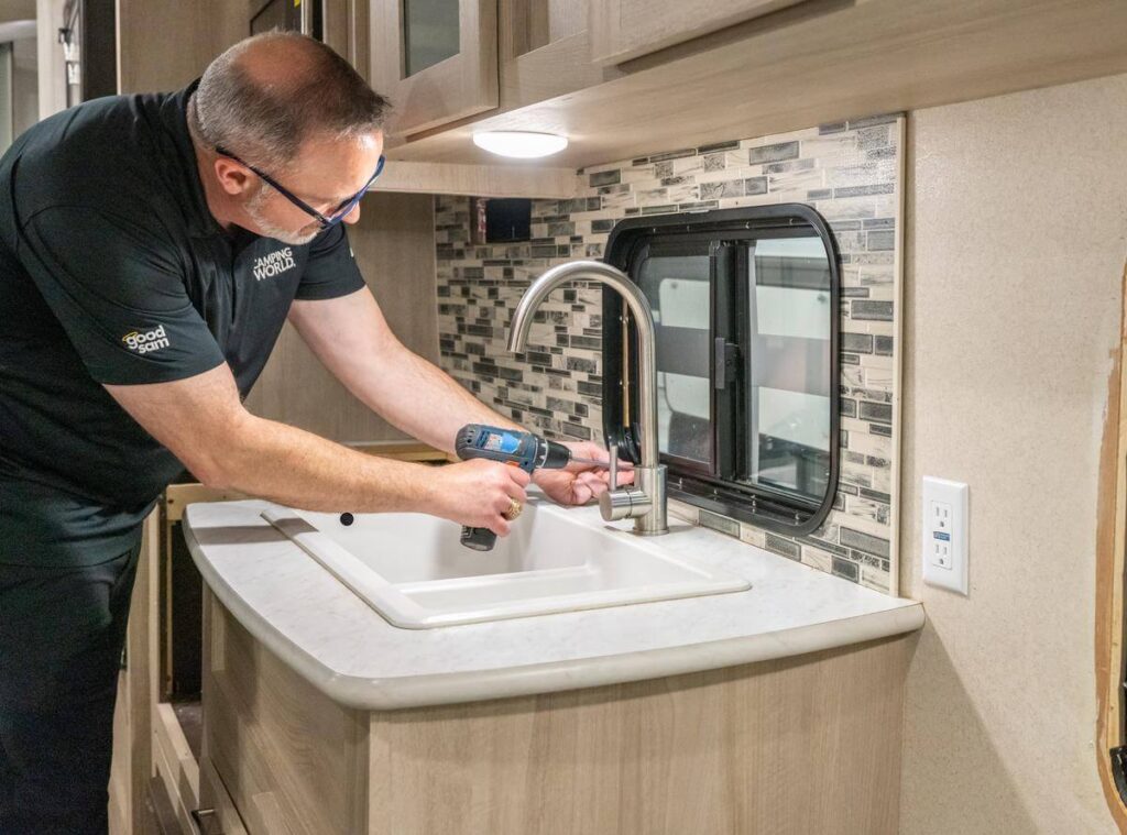 Technician fixing issue in RV kitchen