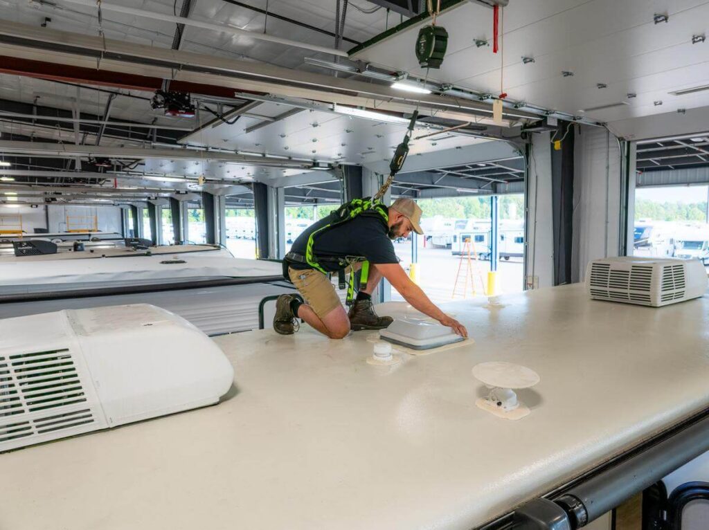 Technician inspecting RV roof