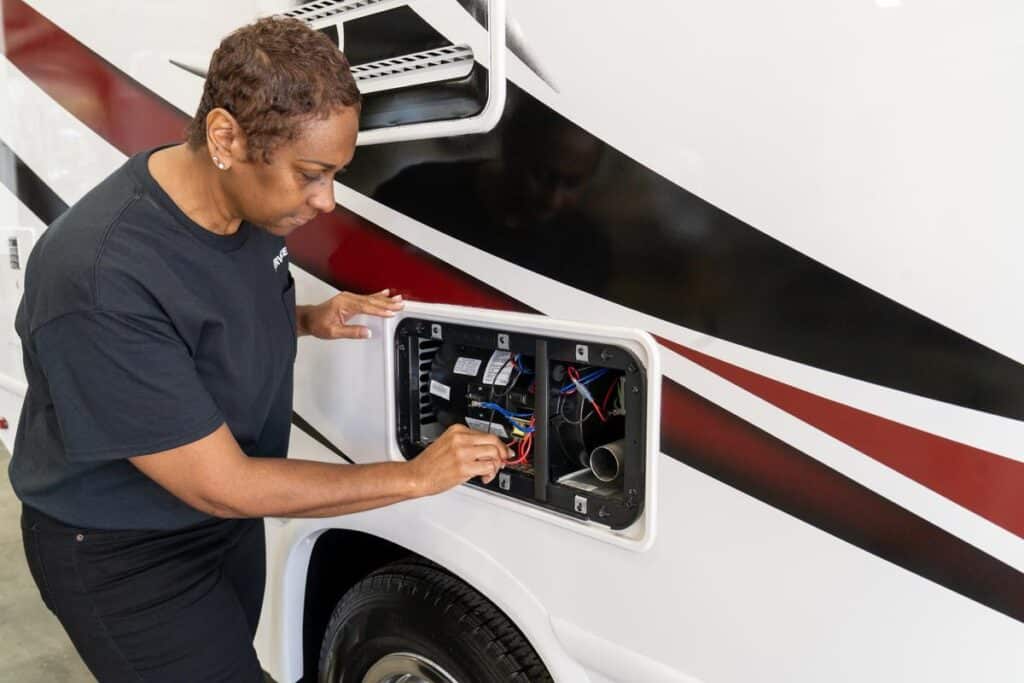 Woman making an camper furnace repair