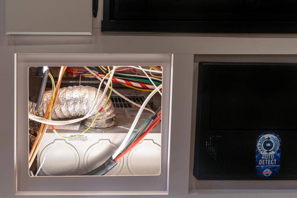 RV furnace with return air vent panel removed for repair or service